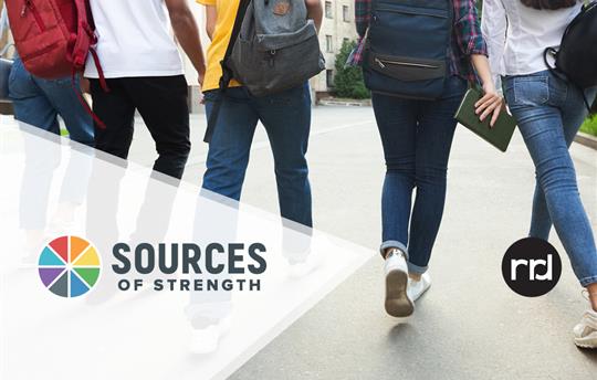 teenagers walking with backpacks away from the camera